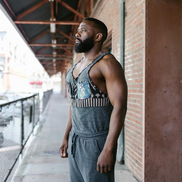 Man performing a bodyweight strength exercise in a modern gym.